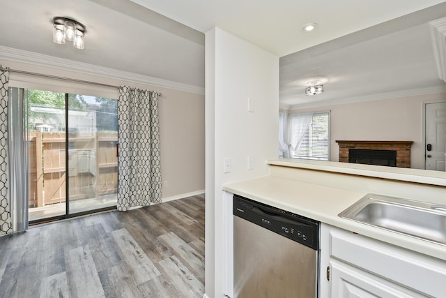 3440 S Delaware Ave Unit 114, Springfield, MO 65804 - kitchen with dishwasher, light countertops, white cabinetry, plenty of natural light, and crown molding