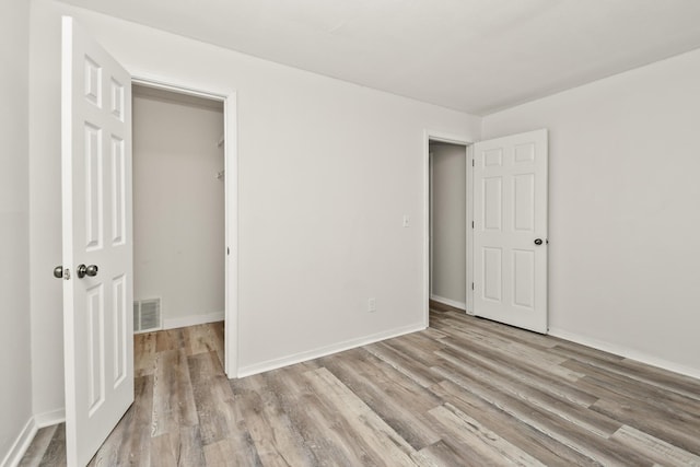 3440 S Delaware Ave Unit 114, Springfield, MO 65804 - unfurnished bedroom featuring wood finished floors and a spacious closet