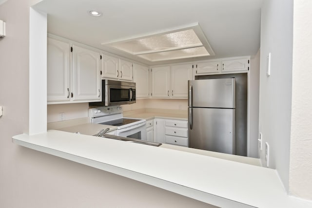 3440 S Delaware Ave Unit 114, Springfield, MO 65804 - kitchen featuring appliances with stainless steel finishes, recessed lighting, white cabinetry, light countertops, and a peninsula