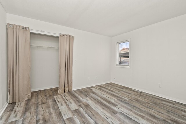 3440 S Delaware Ave Unit 114, Springfield, MO 65804 - unfurnished bedroom with wood finished floors and a closet
