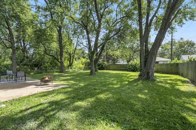2558 S Nettleton Ave, Springfield, MO 65807 - fenced backyard featuring an outdoor fire pit and a patio area