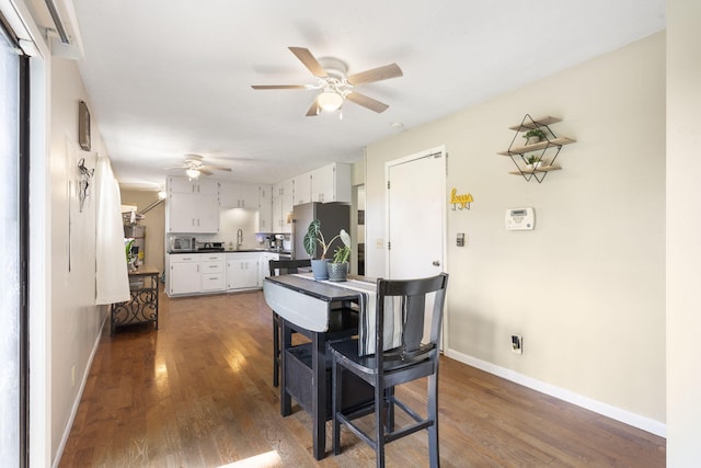 2558 S Nettleton Ave, Springfield, MO 65807 - kitchen featuring freestanding refrigerator, ceiling fan, dark wood-style floors, and dark countertops