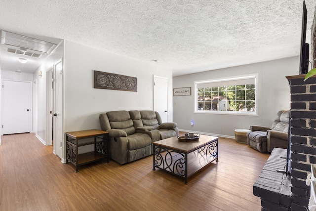 2558 S Nettleton Ave, Springfield, MO 65807 - living room featuring wood finished floors and a textured ceiling