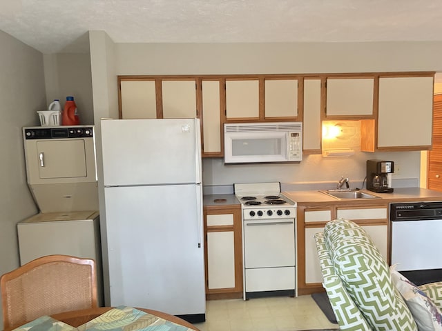 3 Memory Ln Unit 1, Branson, MO 65616 - kitchen featuring white appliances, stacked washer / dryer, light floors, and light countertops