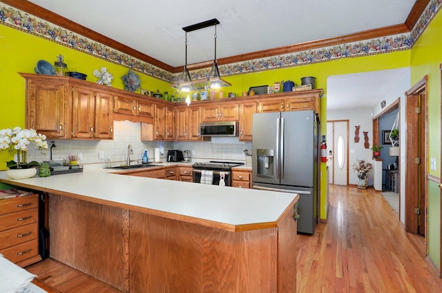 311 Northview Rd, Nixa, MO 65714 - kitchen featuring stainless steel appliances, a peninsula, decorative backsplash, and light wood finished floors