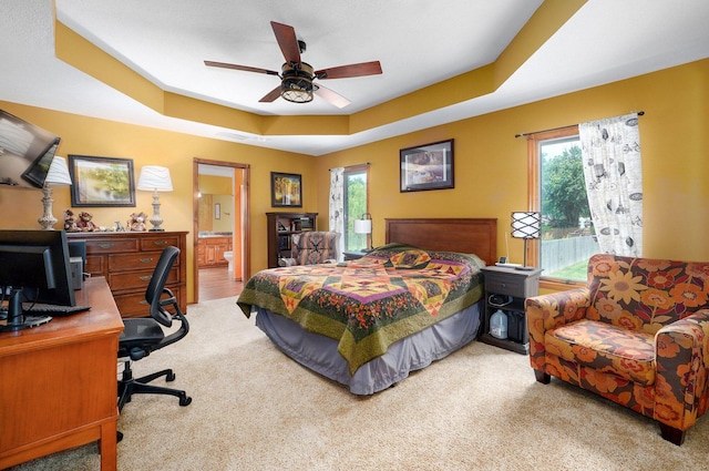 311 Northview Rd, Nixa, MO 65714 - carpeted bedroom featuring an office area, multiple windows, a tray ceiling, and connected bathroom