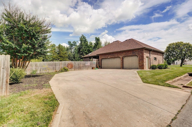 311 Northview Rd, Nixa, MO 65714 - view of property exterior with an attached garage, brick siding, driveway, and a shingled roof