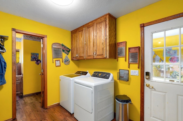 311 Northview Rd, Nixa, MO 65714 - laundry area with cabinet space, wood finished floors, washing machine and dryer, and a textured ceiling
