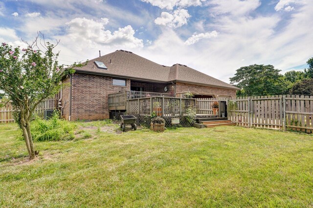 311 Northview Rd, Nixa, MO 65714 - rear view of property with brick siding, a deck, a fenced backyard, and roof with shingles