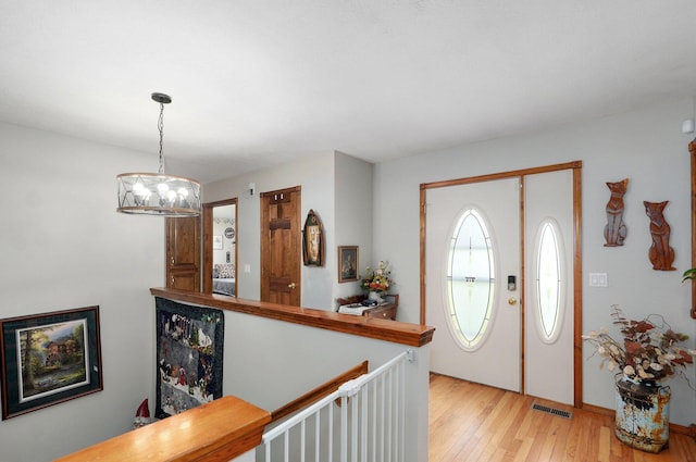 311 Northview Rd, Nixa, MO 65714 - entrance foyer with light wood-type flooring and a chandelier