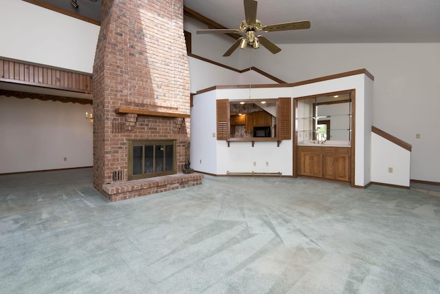 3501 E Cooper Blvd, Springfield, MO 65802 - unfurnished living room featuring ceiling fan, carpet, high vaulted ceiling, and a brick fireplace