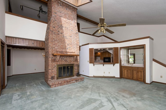 3501 E Cooper Blvd, Springfield, MO 65802 - unfurnished living room featuring ceiling fan, carpet, high vaulted ceiling, a fireplace, and a textured ceiling