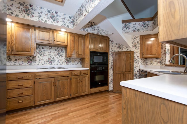 3501 E Cooper Blvd, Springfield, MO 65802 - kitchen featuring black appliances, wallpapered walls, light wood-style floors, light countertops, and brown cabinets