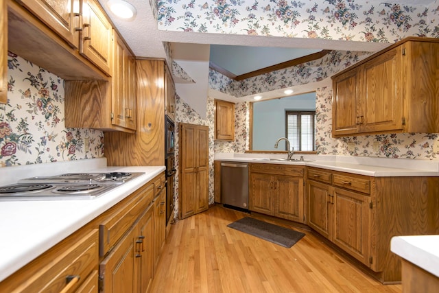 3501 E Cooper Blvd, Springfield, MO 65802 - kitchen with wallpapered walls, appliances with stainless steel finishes, brown cabinetry, and light wood-type flooring