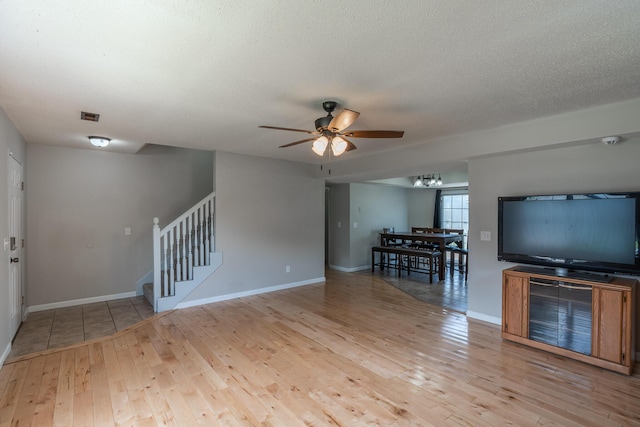 2981 W Highpoint St, Springfield, MO 65810 - living area with a ceiling fan, hardwood / wood-style floors, stairs, and a chandelier