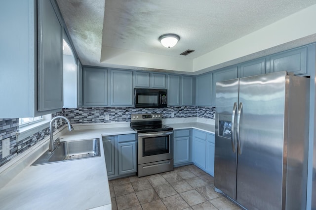 2981 W Highpoint St, Springfield, MO 65810 - kitchen with appliances with stainless steel finishes, a textured ceiling, backsplash, and light countertops