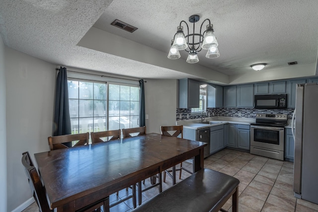 2981 W Highpoint St, Springfield, MO 65810 - dining space featuring a textured ceiling, a chandelier, and light tile patterned floors
