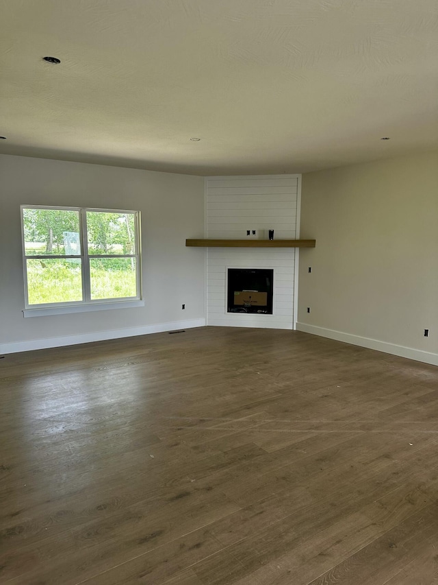 5569 E Wild Horse Dr, Springfield, MO 65802 - unfurnished living room with dark wood finished floors and a fireplace