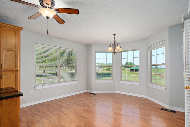 287 N Metzletein Rd, Billings, MO 65610 - unfurnished dining area with light wood-type flooring, a chandelier, a textured ceiling, and a ceiling fan