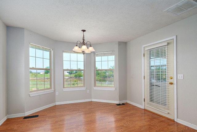287 N Metzletein Rd, Billings, MO 65610 - unfurnished dining area with wood finished floors, plenty of natural light, a chandelier, and a textured ceiling
