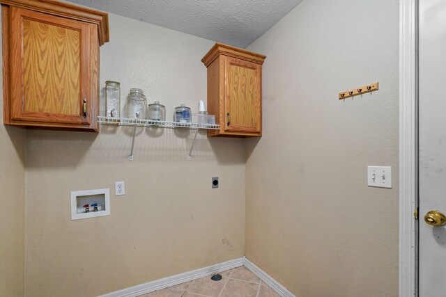 287 N Metzletein Rd, Billings, MO 65610 - laundry room featuring hookup for an electric dryer, hookup for a washing machine, cabinet space, light tile patterned floors, and a textured ceiling