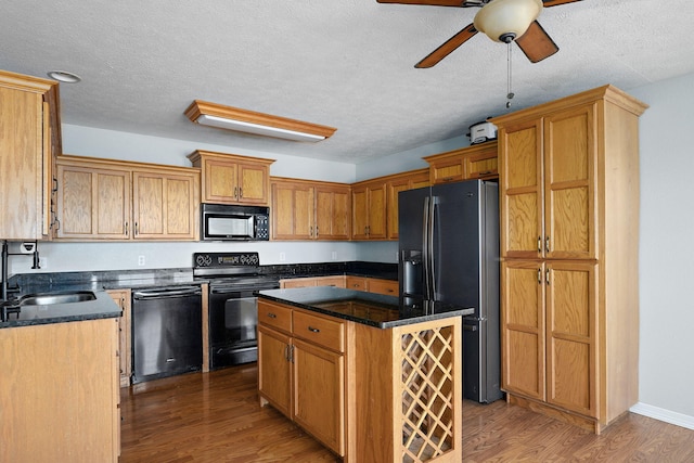 287 N Metzletein Rd, Billings, MO 65610 - kitchen with black appliances, ceiling fan, wood finished floors, a center island, and dark stone counters