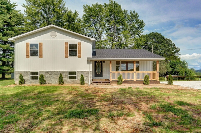 7208 N Farm Rd Unit 133, Springfield, MO 65803 - split level home featuring covered porch, a front yard, and stone siding