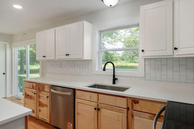 7208 N Farm Rd Unit 133, Springfield, MO 65803 - kitchen featuring stainless steel dishwasher, light countertops, black / electric stove, backsplash, and healthy amount of natural light