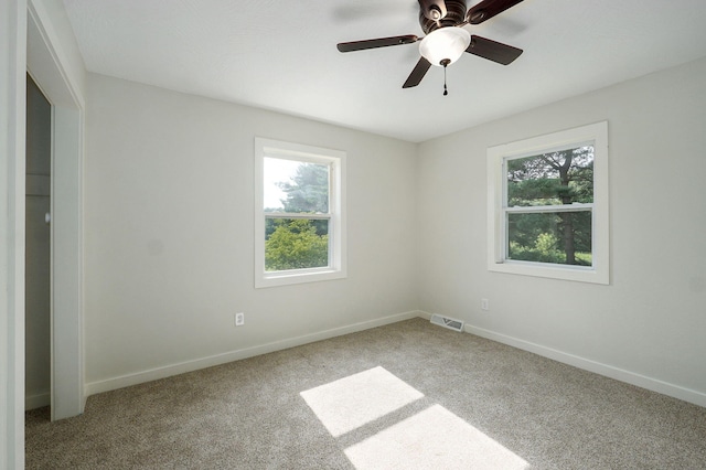 7208 N Farm Rd Unit 133, Springfield, MO 65803 - empty room with healthy amount of natural light, carpet floors, and ceiling fan