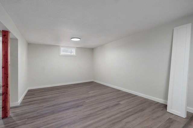 7208 N Farm Rd Unit 133, Springfield, MO 65803 - unfurnished room featuring dark wood-style floors and a textured ceiling