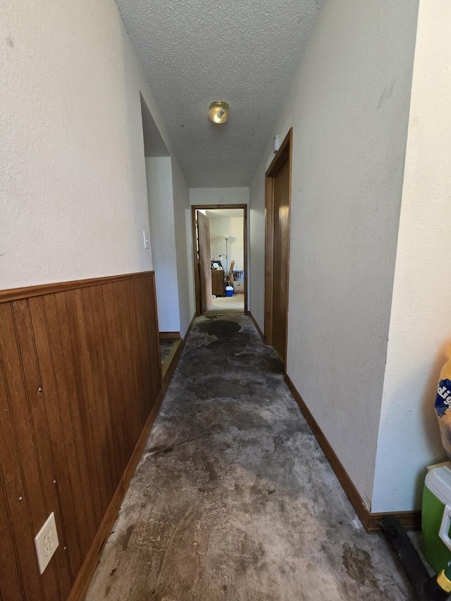 445 Monroe St, Thayer, MO 65791 - hall with a textured ceiling, a textured wall, carpet, and wood walls
