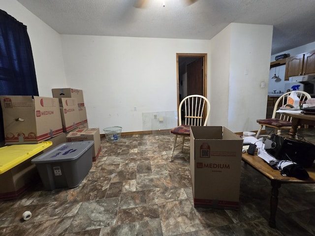 445 Monroe St, Thayer, MO 65791 - dining space featuring stone finish flooring, a ceiling fan, and a textured ceiling