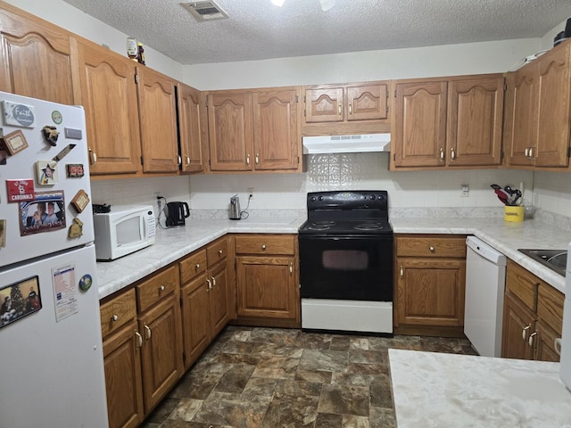 445 Monroe St, Thayer, MO 65791 - kitchen featuring white appliances, under cabinet range hood, light countertops, brown cabinets, and a textured ceiling