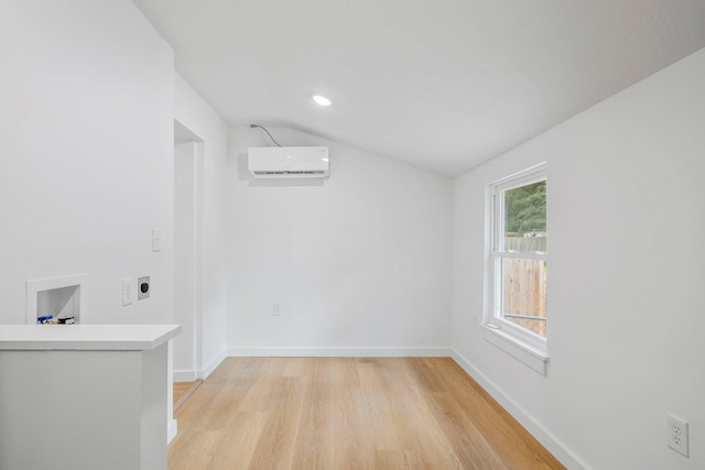 934 S New Ave, Springfield, MO 65806 - empty room featuring a wall mounted air conditioner, vaulted ceiling, light wood-style flooring, and recessed lighting