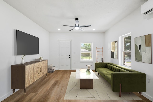 934 S New Ave, Springfield, MO 65806 - living room featuring a wall mounted air conditioner, light wood finished floors, a ceiling fan, and recessed lighting