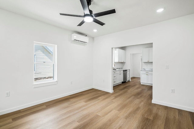 934 S New Ave, Springfield, MO 65806 - unfurnished living room with a wall mounted air conditioner, a ceiling fan, light wood-style flooring, and recessed lighting