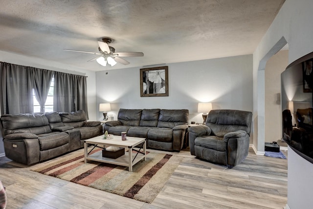 1908 Hazel St, Carthage, MO 64836 - living room featuring light wood-style floors, ceiling fan, and a textured ceiling
