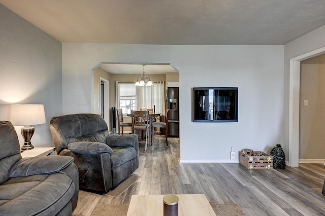 1908 Hazel St, Carthage, MO 64836 - living area featuring arched walkways, a chandelier, and wood finished floors
