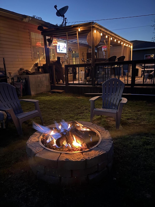 1908 Hazel St, Carthage, MO 64836 - view of green lawn featuring an outdoor fire pit and a deck