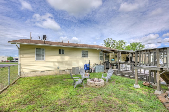 1908 Hazel St, Carthage, MO 64836 - rear view of property featuring a fire pit, crawl space, and a wooden deck