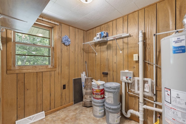 595 Johns Ford Rd, Sparta, MO 65753 - laundry area with water heater, hookup for a washing machine, wood walls, and light tile patterned flooring