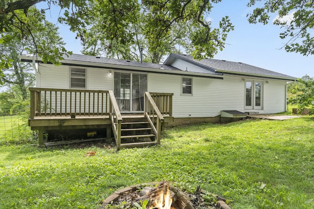 595 Johns Ford Rd, Sparta, MO 65753 - back of house featuring a wooden deck, a fire pit, a lawn, and a shingled roof