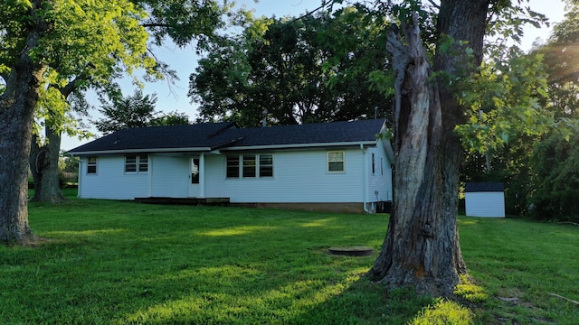 595 Johns Ford Rd, Sparta, MO 65753 - back of property featuring a lawn and a storage shed