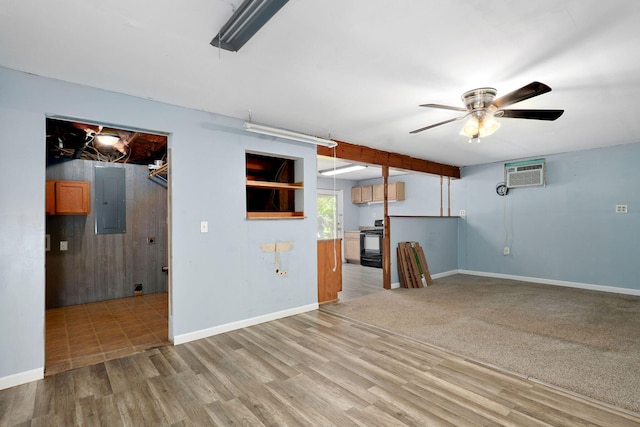 1311 S 9th St, Ozark, MO 65721 - unfurnished living room featuring electric panel, a ceiling fan, an AC wall unit, and wood finished floors
