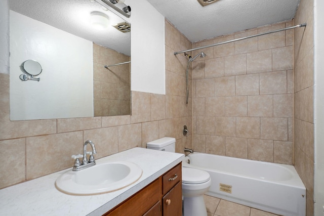 1311 S 9th St, Ozark, MO 65721 - bathroom with vanity, shower / washtub combination, a textured ceiling, tile walls, and tile patterned floors