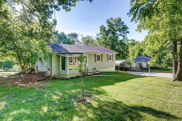 1311 S 9th St, Ozark, MO 65721 - view of front facade with a detached carport, a front yard, and driveway