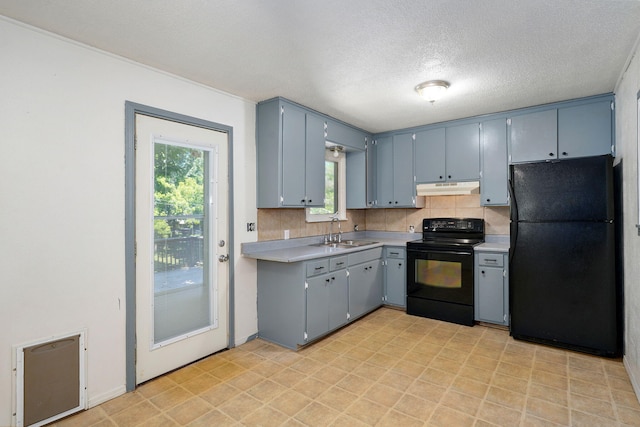 1311 S 9th St, Ozark, MO 65721 - kitchen with black appliances, under cabinet range hood, light countertops, tasteful backsplash, and a textured ceiling