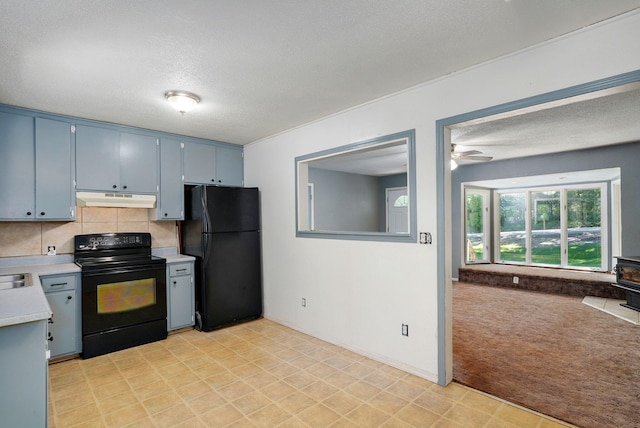 1311 S 9th St, Ozark, MO 65721 - kitchen featuring black appliances, under cabinet range hood, a textured ceiling, light countertops, and backsplash