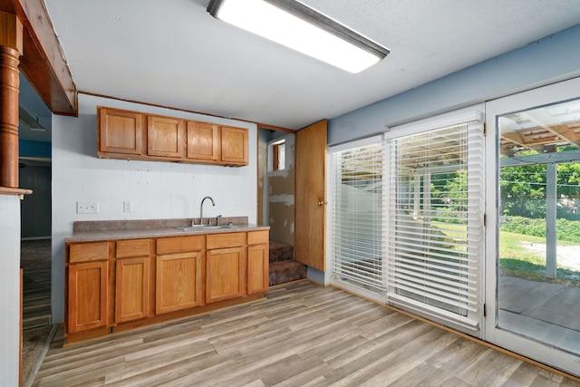 1311 S 9th St, Ozark, MO 65721 - kitchen with light wood-type flooring, healthy amount of natural light, and brown cabinets