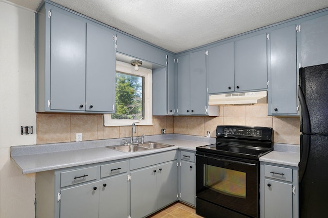 1311 S 9th St, Ozark, MO 65721 - kitchen featuring black appliances, under cabinet range hood, backsplash, light countertops, and a textured ceiling